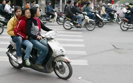 One of common road violation that three people in one motorcyle One of common road violation that three people in one motorcyle
